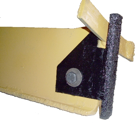 Bolt-on scraper protects discharge ring