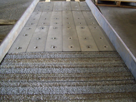 Chute with Kenco Alloy-K wear plates in sliding abrasion zone; TCI plates in impact zone.